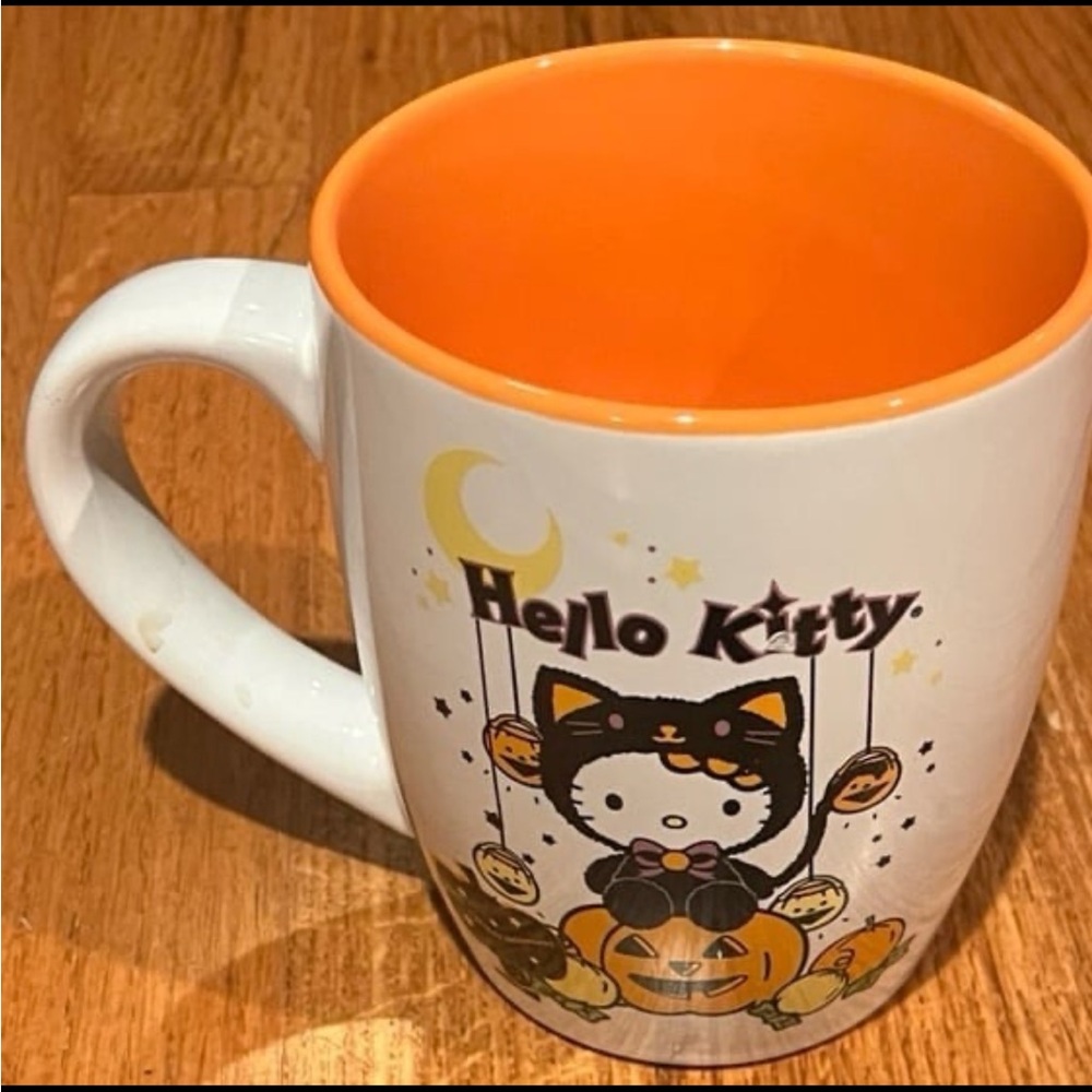 Hello kitty Halloween pumpkin mug. Pictures on both sides of cup